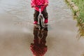 Little girl riding bike in water puddle Royalty Free Stock Photo