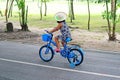 Little Girl Riding a Blue Bicycle