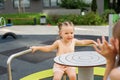 Little girl riding carousel in playground outdoor. Sensory experience. Baby development Royalty Free Stock Photo