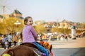 Little girl riding festive horse Royalty Free Stock Photo