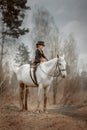 Little girl in riding habit with horse and vizsla Royalty Free Stock Photo