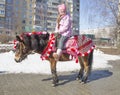 Little girl riding her pony on