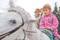 Little girl riding horse and looking aside Royalty Free Stock Photo