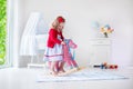 Little girl riding a toy horse Royalty Free Stock Photo