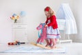 Little girl riding a toy horse Royalty Free Stock Photo