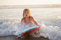 Little girl riding wave on boogie board Royalty Free Stock Photo