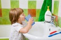 Little girl rinses a mouth after toothbrushing.