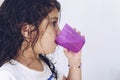 Little girl rinsing her mouth after brushing teeth