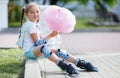 Little girl on roller skates in park.