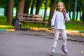 Little girl in roller skates at a park Royalty Free Stock Photo