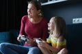 Little girl with her mother play video games, close-up Royalty Free Stock Photo