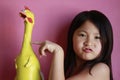 Little girl with rubber chicken Royalty Free Stock Photo