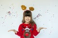 Little girl in rudolf hat waiting for a Christmas on white background. Royalty Free Stock Photo