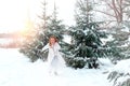 Little girl runing near firs