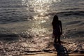 happy little girl run along the sea coast of sunrise behind Royalty Free Stock Photo