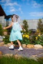 Little girl running around with wings on his back