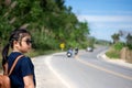 Little girl running away on the road ahead