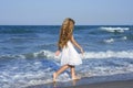 Little girl running beach in blue sea Royalty Free Stock Photo