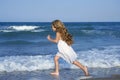 Little girl running beach in blue sea Royalty Free Stock Photo