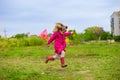 A little girl is running with butterfly net having fun Royalty Free Stock Photo