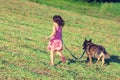 Little girl running with dog in the green field Royalty Free Stock Photo