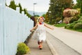 Little girl running down the street Royalty Free Stock Photo