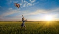 Little girl running on field with kite Royalty Free Stock Photo