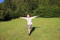 Little girl running on green field Royalty Free Stock Photo