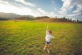 Little girl running with kite happy and smiling on summer field Royalty Free Stock Photo