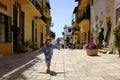 A little girl runs happily in the picturesque Italian village. San Felice Circeo, Lazio, Italy