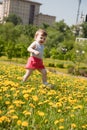 Little girl runs on a meadow