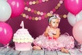 The little girl`s birthday girl was smeared into a cake. The first cake. The use of the first cake. Smash cake. Royalty Free Stock Photo