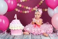 The little girl`s birthday girl was smeared into a cake. The first cake. The use of the first cake. Smash cake. Royalty Free Stock Photo