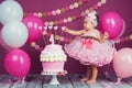 The little girl`s birthday girl was smeared into a cake. The first cake. The use of the first cake. Smash cake. Royalty Free Stock Photo