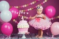 The little girl`s birthday girl was smeared into a cake. The first cake. The use of the first cake. Smash cake. Royalty Free Stock Photo