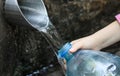 Water flows into the bottle Royalty Free Stock Photo