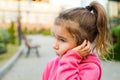 A little girl with a sad and frightened face holds her cheek with her hand - a tooth hurts. Ear pain, toothache, swollen cheek and Royalty Free Stock Photo