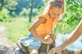 Little girl in the saddle riding on a donkey, in contact farm zoo Royalty Free Stock Photo