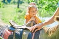 Little girl in the saddle riding on a donkey, in contact farm zoo Royalty Free Stock Photo