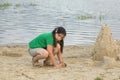 Little girl with sand castle Royalty Free Stock Photo