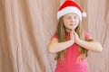 Little girl in santa claus hat dreaming about gifts for new year and christmas copy space Royalty Free Stock Photo