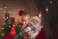 Little girl and Santa decorating Christmas tree