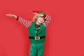 Little girl in Santa elf helper costume on bright red vivid color background Royalty Free Stock Photo