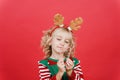 Little girl in Santa elf helper costume on bright red vivid color background Royalty Free Stock Photo