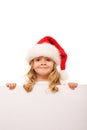 Little girl with santa hat and cardboard banner