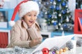 Little girl in Santa hat with laptop Royalty Free Stock Photo