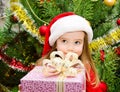 Little girl in santa hat with present have a christmas Royalty Free Stock Photo