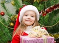 Little girl in santa hat with present have a christmas Royalty Free Stock Photo