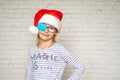 Little girl in Santa hat wearing occluder and eyeglasses, treatment of amblyopia and poor eyesight