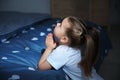 Little girl saying bedtime prayer near bed in room Royalty Free Stock Photo